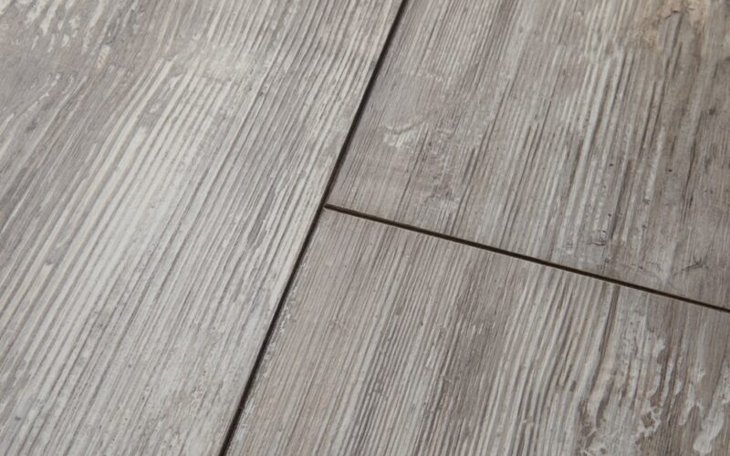 A close up image of gray colored wood look floor planks.