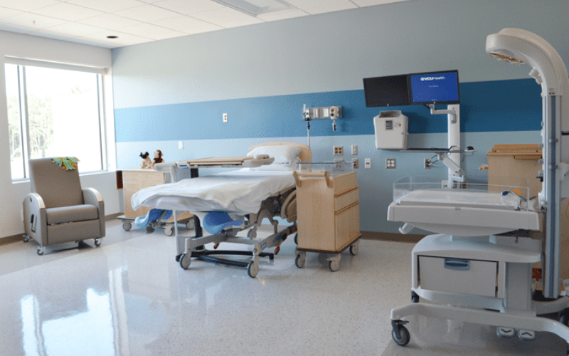 hospital delivery room with white tile floors and blue walls